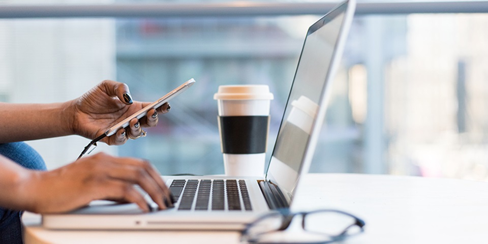 Side view of woman using laptop