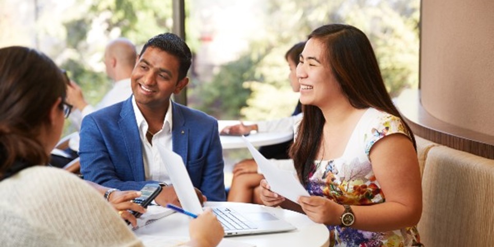 Students having a discussion around a table