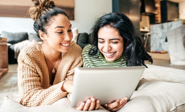 Two girls looking at their iPad