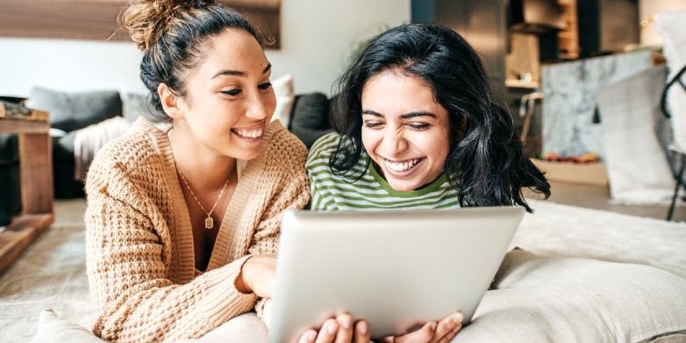 Two girls looking at their iPad