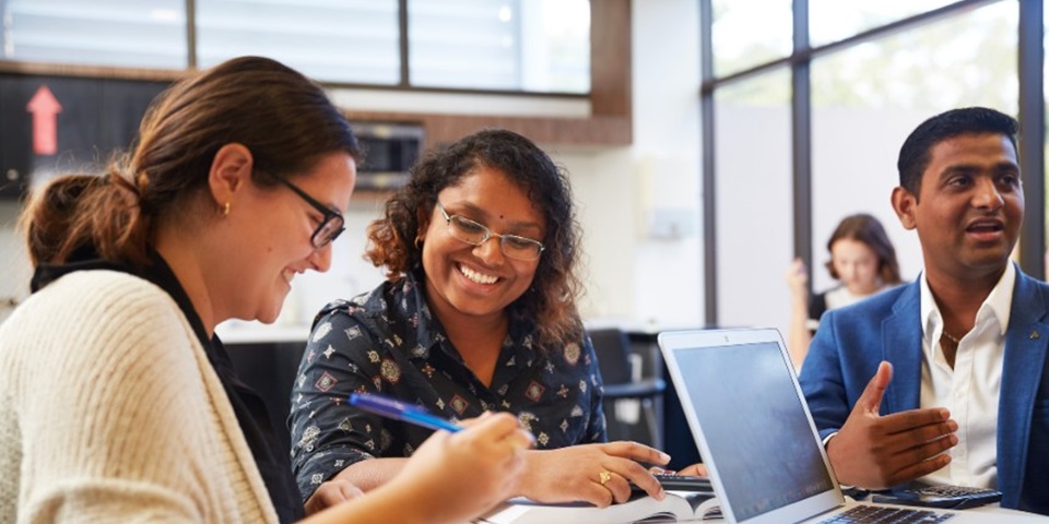 Three people working together at a table