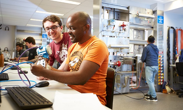 Two male students in engineering lab