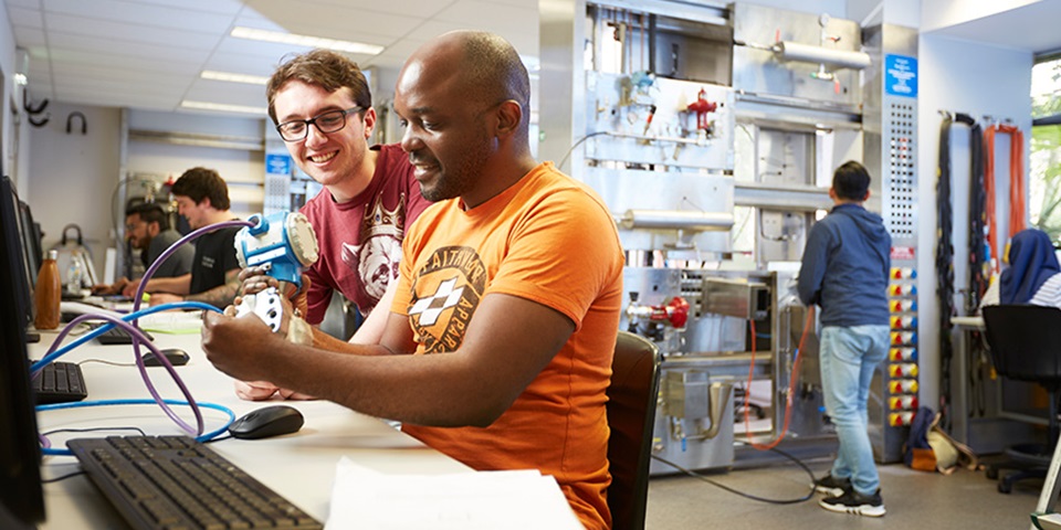 Two male students in engineering lab