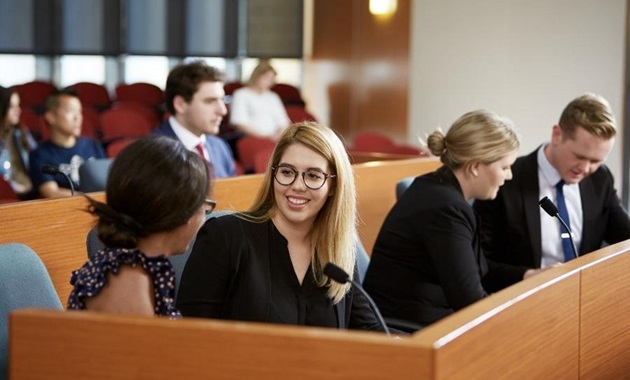 Lawyers talking amongst themselves in a courtroom