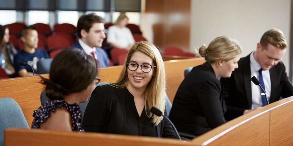 Lawyers talking amongst themselves in a courtroom