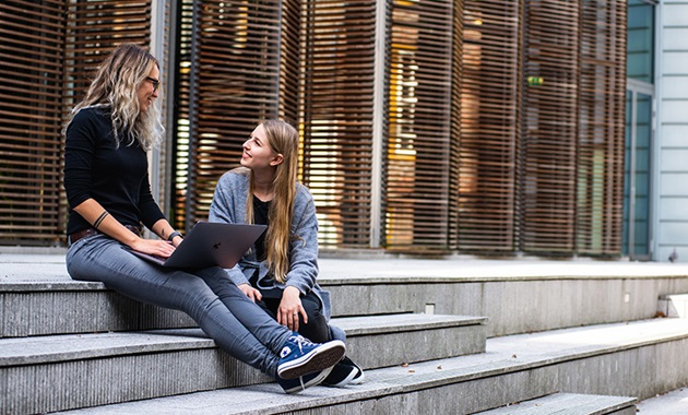 Woman and daughter sitting on stairs