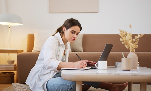 Woman writing at study desk