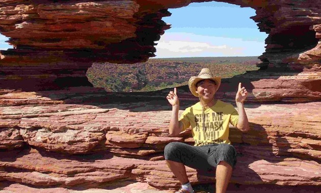 Murdoch student Yuki Iwasaki sitting at the top of a gorge