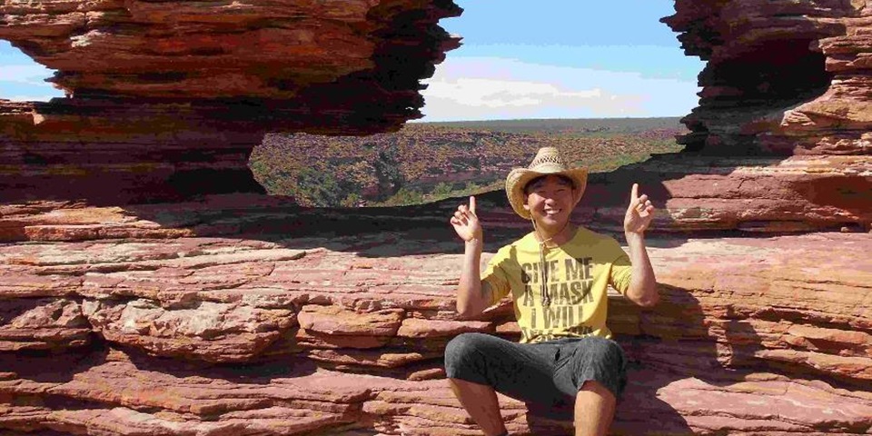 Murdoch student Yuki Iwasaki sitting at the top of a gorge